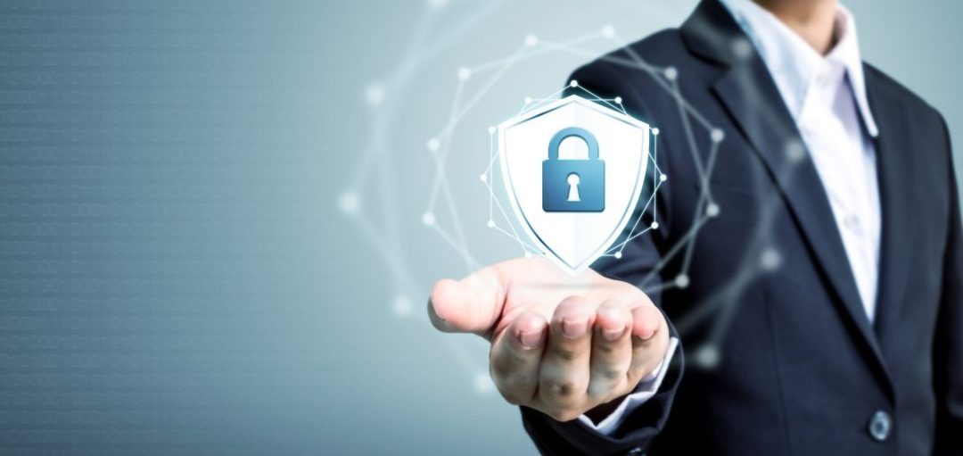 A businessman in a suit holds out his hand, displaying a digital shield icon with a padlock, symbolizing security and protection. This image represents the concept of DNS monitoring and safeguarding DNS to prevent cyber threats and ensure safe internet navigation.