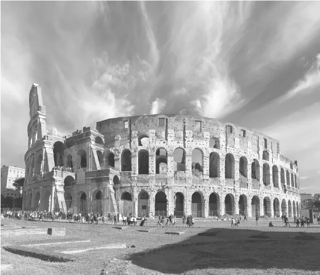 The Colosseum in Rome, an iconic symbol of ancient history, showcasing its grand structure with multiple arches and a partially collapsed section, set against a dramatic sky.