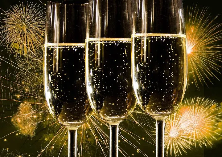 Three champagne flutes filled with sparkling liquid are prominently displayed against a backdrop of colourful fireworks. The image symbolizes the launch of a new DNS monitoring platform designed to protect your DNS effectively.