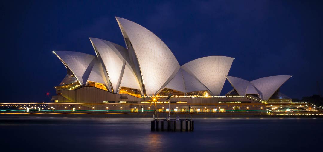 A picture of Sydney opera house by night taken from the Campbells Cove.